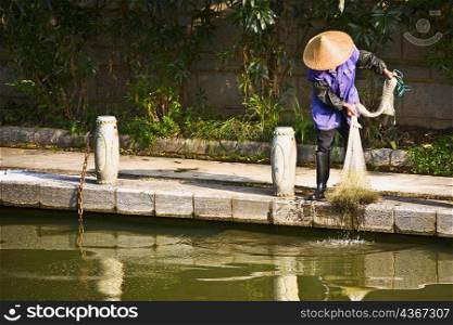 Fisherman holding a fishing net, Guilin, Guangxi Province, China