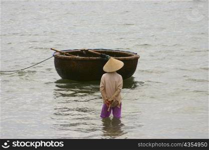 Fisherman in the sea with his tub boat, Hoi An, Vietnam