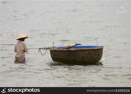 Fisherman in the sea with his tub boat, Hoi An, Vietnam