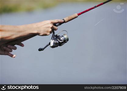 fisherman s hand fishing blurred background