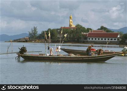 Fisherman standing on a fishing boat, Koh Samui, Thailand
