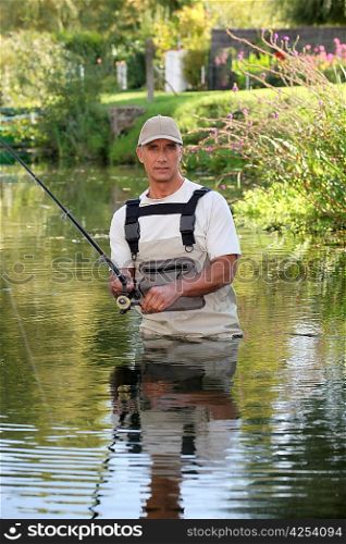 Fisherman stuck in river