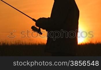 fisherman throws fishing tackles
