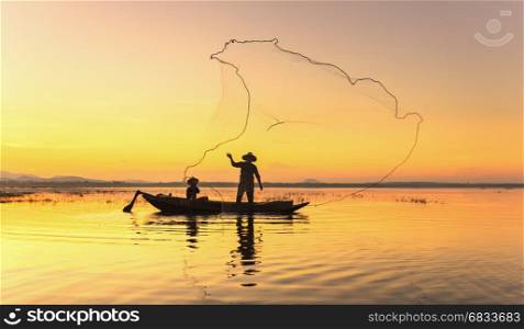 Fishermen fishing in the early morning golden light