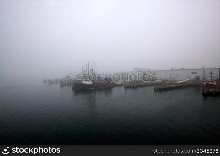 Fishermen&rsquo;s wharf covered in dense morning fog.