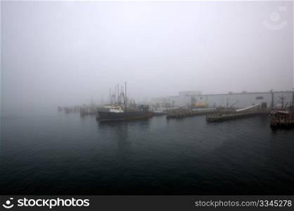 Fishermen&rsquo;s wharf covered in dense morning fog.