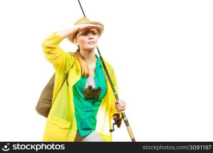 Fishery, spinning equipment, angling sport, activity concept. Woman wearing raincoat holding fishing rod and binoculars, ready for adventure.. Woman with fishing rod, spinning equipment