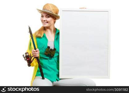 Fishery, spinning equipment, angling sport and activity concept. Happy woman with fishing rod holding blank white board with copyspace.. Happy woman with fishing rod holding board