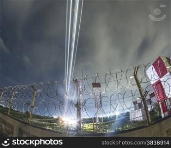 Fisheye view of aiport over barbed wire fence