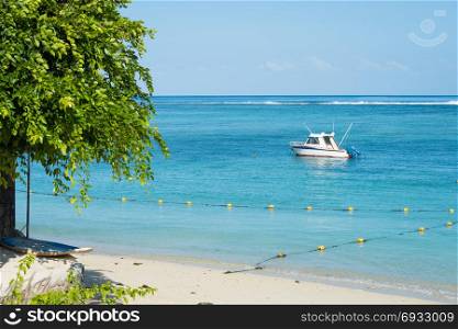 Fishing boat anchored near the shore of day beach,mauritius beach Flic and Flac.