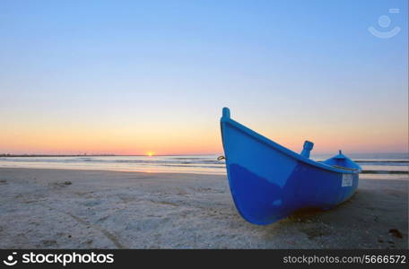 Fishing boat and sunrise on Black Sea beach