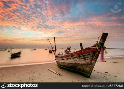Fishing boat in a harbor with sunset in holiday