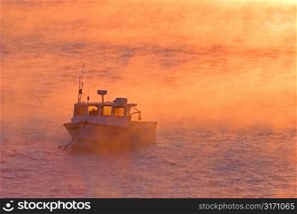 Fishing Boat in Orange Mist on Open Water