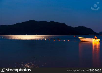 fishing boat in the night a calm sea