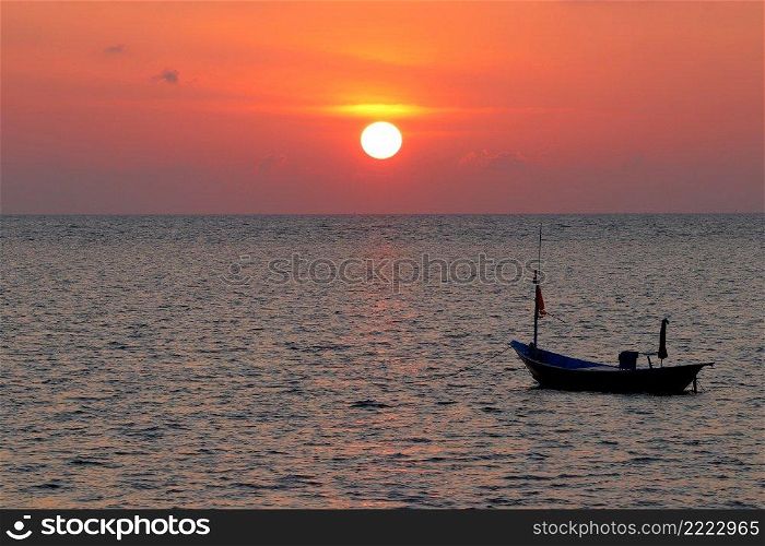 fishing boat in the sea with beautiful sunset background
