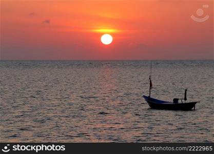 fishing boat in the sea with beautiful sunset background