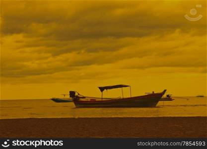 Fishing boat on the beach and sunset