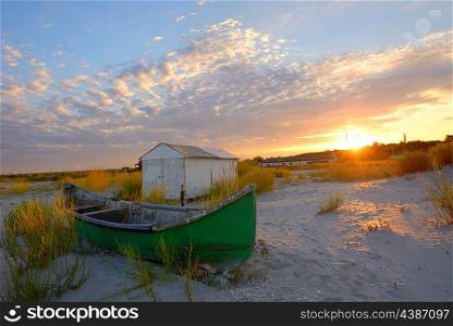 Fishing boat on the beach at sunset time