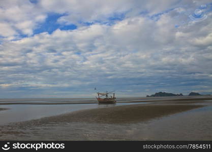 Fishing boat on the beach in summer