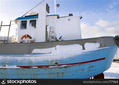 Fishing boat on the beach in winter