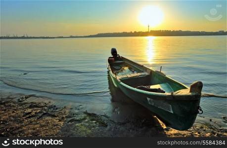 Fishing boat on the shore of Danube, at sunset