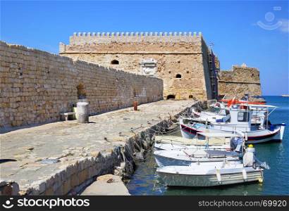 Fishing boats and Venetian Fortress in Heraklion, Crete Island, Greece