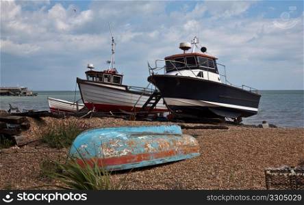 Fishing boats beached on stony beach of Deal on Kent coast of England