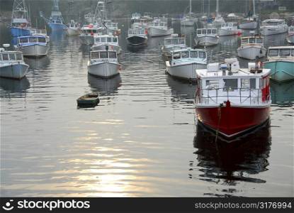 Fishing boats in a harbor in Perkins Cove, Maine, on a foggy day