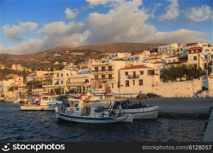 Fishing boats in the bay of greek village at sunrise