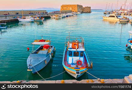 Fishing boats in the harbour near the Venetian Fortress in Heraklion, Crete, Greece