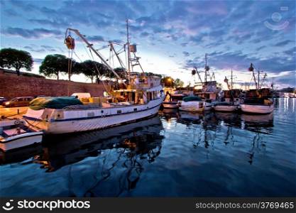 Fishing boats on colorful sunset in Zadar, Croatia