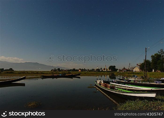 Fishing boats on waterway at dusk, Nyaung Shwe, Inle Lake, Burma