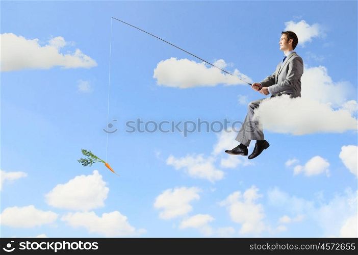 Fishing concept. Businessman sitting on cloud and fishing with rod