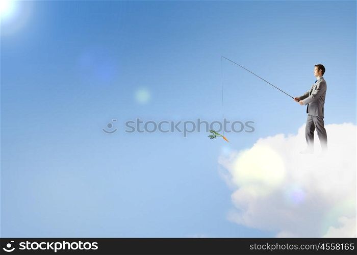 Fishing concept. Businessman standing on cloud and fishing with rod