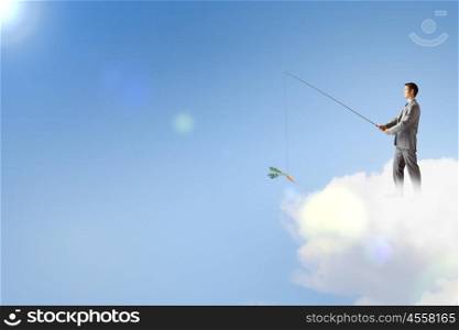 Fishing concept. Businessman standing on cloud and fishing with rod