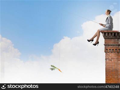 Fishing concept. Businesswoman fishing with rod on top of building