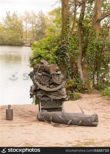 fishing gear resting on the side of a lake hobby