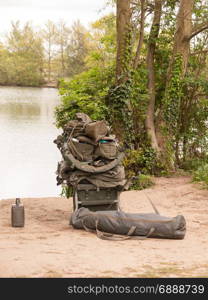 fishing gear resting on the side of a lake hobby