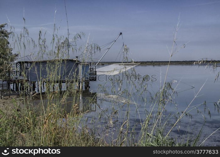 Fishing hut on the Pialassa della Baiona brackish lagoon near Marina Romea along te Adriatic seaside in Ravenna (Italy)