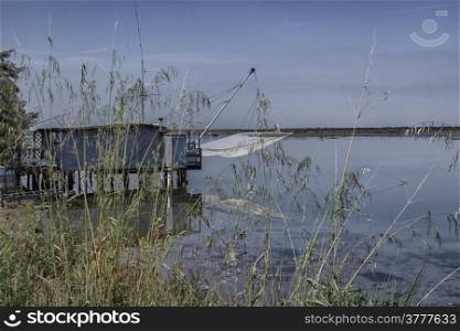 Fishing hut on the Pialassa della Baiona brackish lagoon near Marina Romea along te Adriatic seaside in Ravenna (Italy)