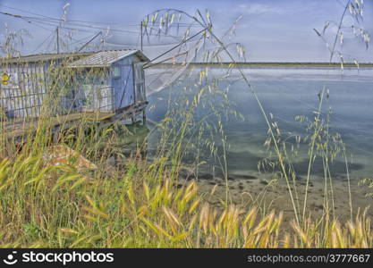 Fishing hut on the Pialassa della Baiona brackish lagoon near Marina Romea along te Adriatic seaside in Ravenna (Italy)