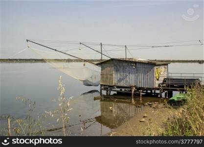 Fishing hut on the Pialassa della Baiona brackish lagoon near Marina Romea along te Adriatic seaside in Ravenna (Italy)