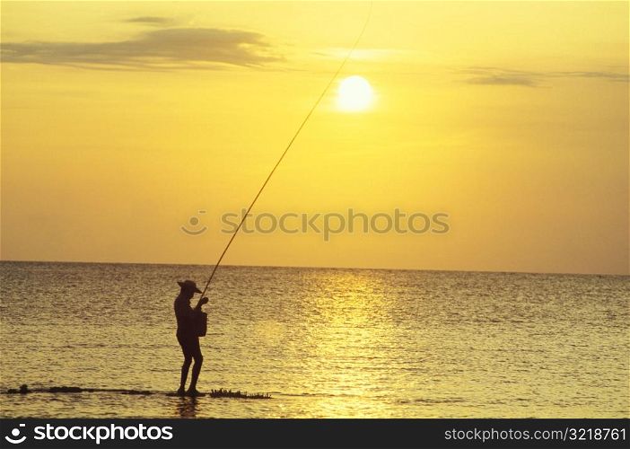Fishing in the Sea at Sunset