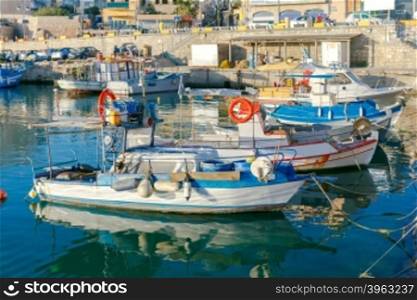 Fishing multi-colored boats in the old harbor of Heraklion in early sunny morning. Crete. Greece.. Heraklion. Fishing boats in the old port.