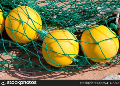 fishing nets woth yellow buoy in Mediterranean Balearic port