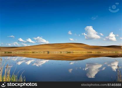 Fishing on a calm water. Hills and sky behind a lake. Belarus