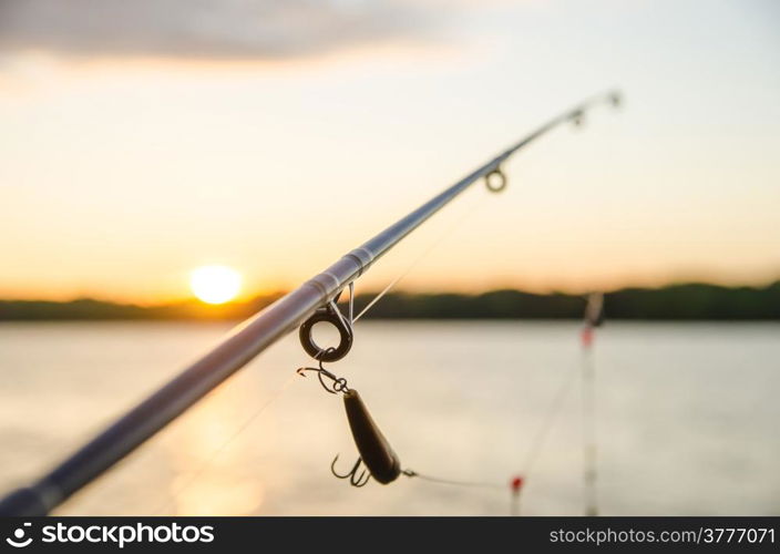 fishing on a lake before sunset