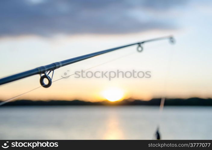 fishing on a lake before sunset