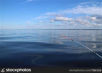 fishing on a quiet summer morning on the lake rod with fishing line stretched