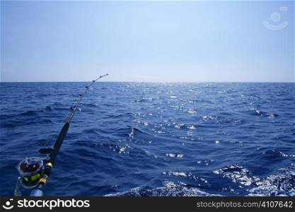Fishing on the boat with trolling rod and reel. Blue Mediterranean sea.